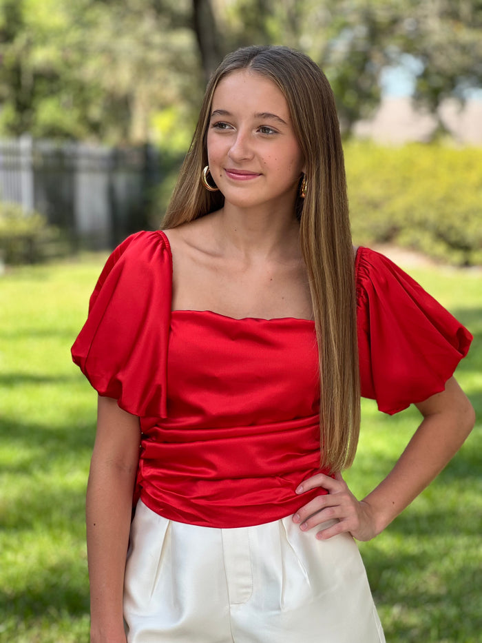 Ravishing in Red, this fiery red top is a symbol of confidence and demands attention. Unleash your inner charm and leave a lasting impression with our Red Off Shoulder Waist Tied Satin Top. Whether it's a romantic dinner or a night out with friends, this top promises to be your ultimate choice for unparalleled style and sophistication.  Zipper on the side