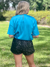 These stunning shorts are designed to make a statement and turn heads at any event. The sequin detailing adds a touch of sparkle and allure, perfect for those who love to shine.  Black sequin shorts Elastic waist band