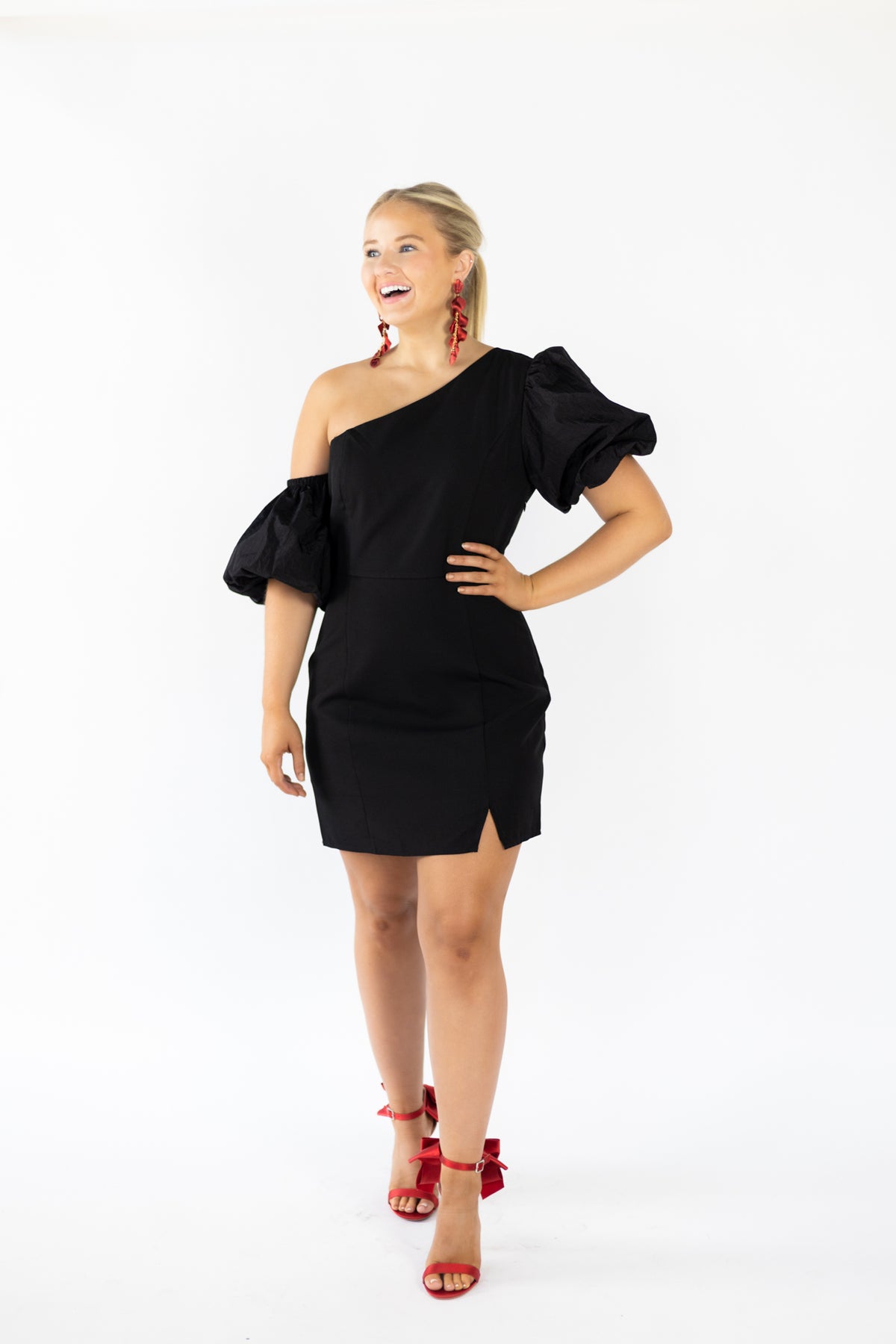 One shoulder mini dress in stretch crepe fabric Asymmetrical neckline, lining, taffeta half sleeves One Sleeve is detached from the shoulder Hidden seam zipper closure on the side. Triangle skirt slit and seam details on the front