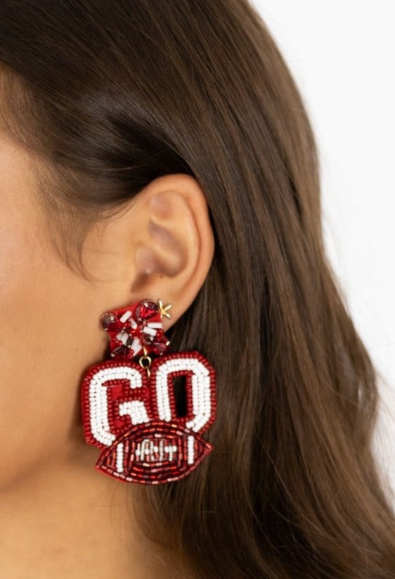 Crimson and White football spirit earrings made with seed bead and crystal embellishments.  Be 'Game Day’ ready with these lightweight earrings.  Materials: felt, rhinestone, crystal accents, and seed beads.